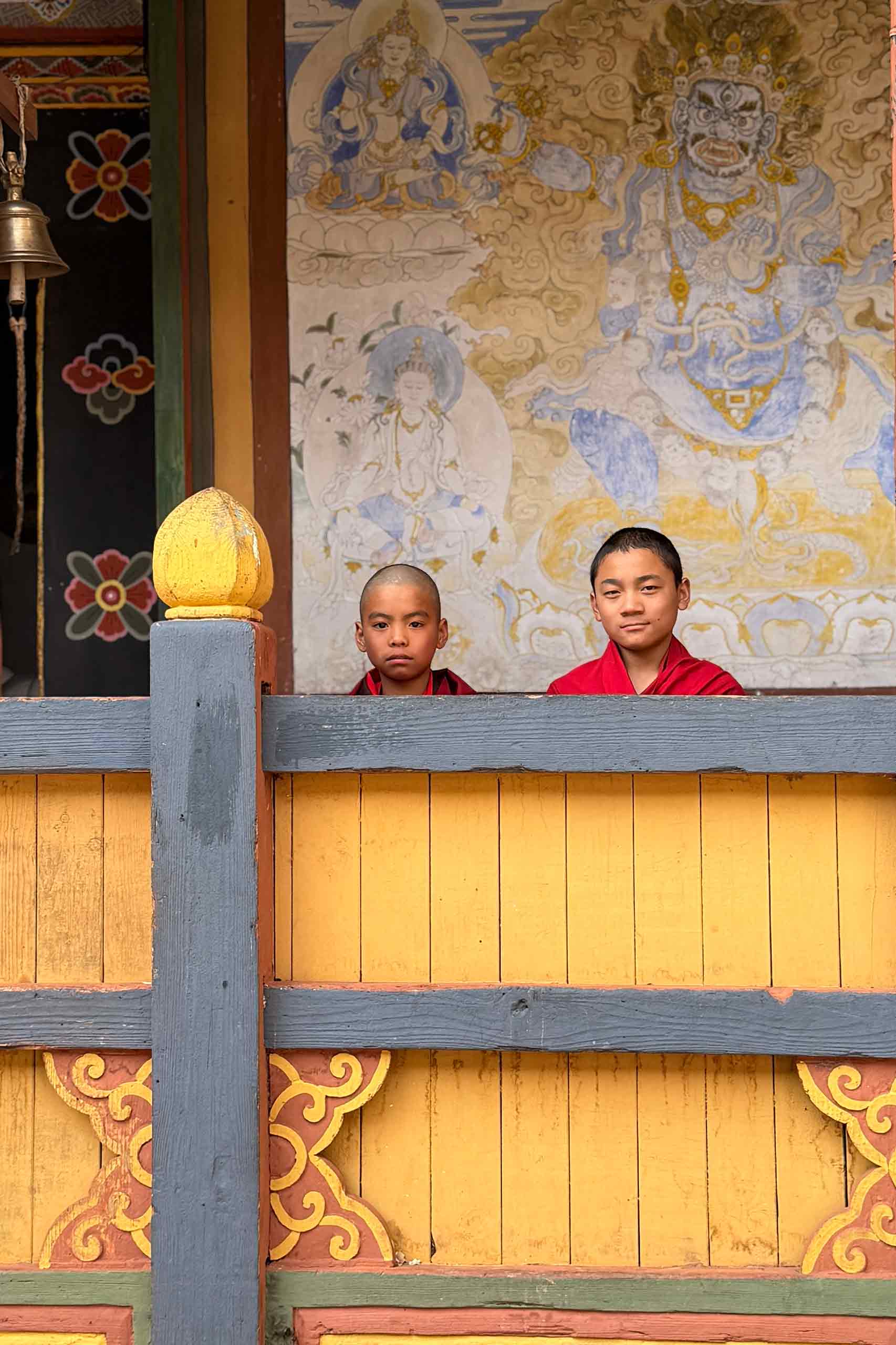 Young Bhutanese Buddhist monk in a monastery, reflecting Dralwa Journeys' philosophy of genuine cultural connection